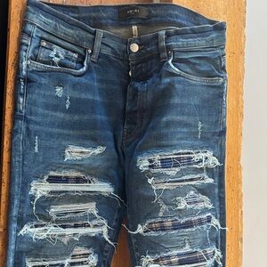 Amiri vintage blue denin distressed with plaid flannel inset repair.